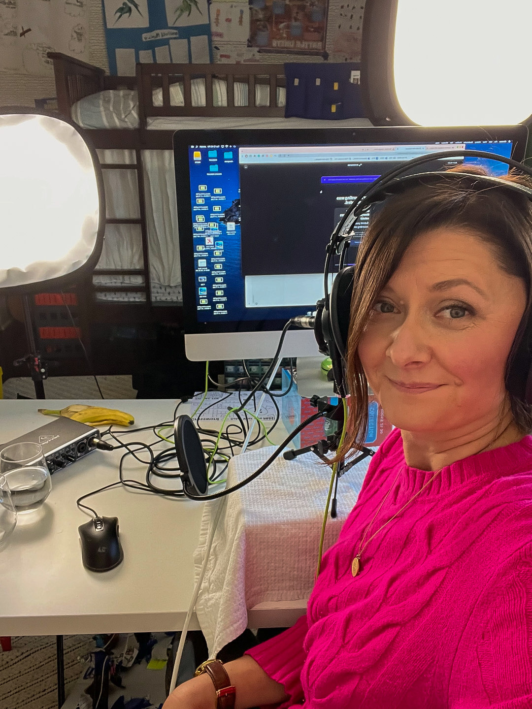 An Image of Rebecca recording a podcast episode in the studio